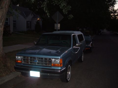 1990 Ford Ranger - A blue Ford Bronco II is parked on a residential street at dusk.
