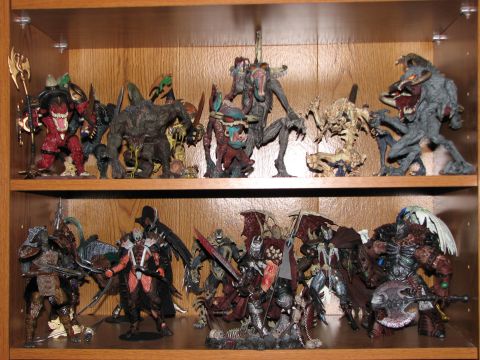 1991 Ford Bronco - A display shelf holds a collection of detailed fantasy and monster action figures.
