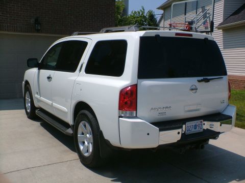 2006 Nissan Armada - Rear view of a white 2006 Nissan Armada SUV with tinted windows and a chrome bumper.