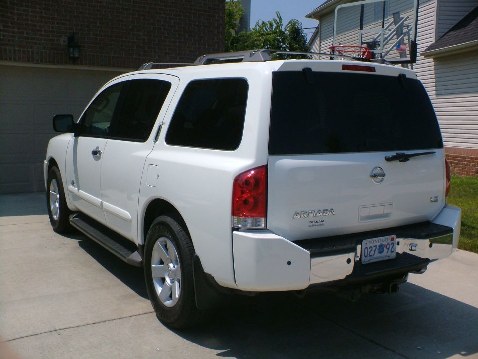 White 2006 Nissan Armada SUV parked in driveway, rear 3/4 view