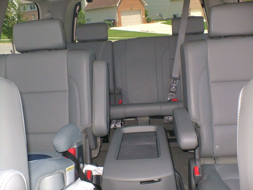 Gray leather second and third row seats inside an SUV or minivan