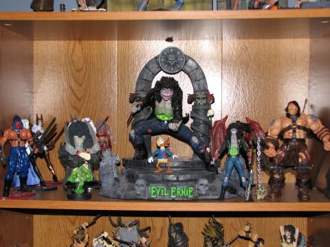 1991 Ford Bronco - A shelf displays a collection of action figures, including a central figure labeled 'Evil Ernie'.