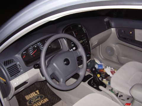 1996 Ford F-150 - Interior view of a car, a dashboard, steering wheel, and a floor mat with Ford branding.