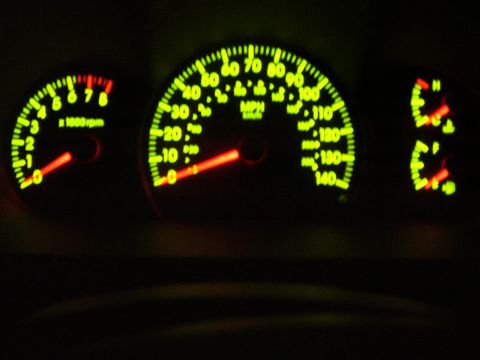 1996 Ford F-150 - The illuminated dashboard gauges show speed and engine RPMs in the dark.
