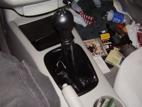 1996 Ford F-150 - Interior view of a car's center console and passenger seat area, filled with various items.