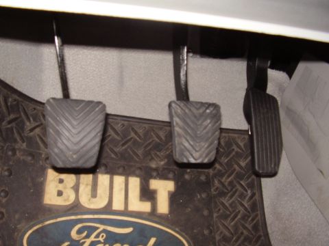 1996 Ford F-150 - The image shows the clutch, brake, and accelerator pedals along with a Ford branded floor mat.