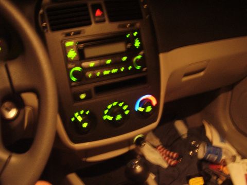 1996 Ford F-150 - Interior view of a car's dashboard, showing the radio and climate controls illuminated with green lights.