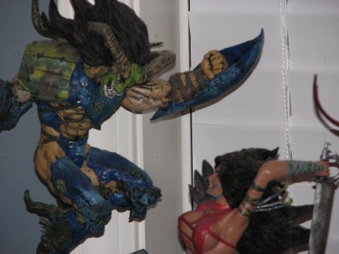 1991 Ford Bronco - Two action figures, a monster and a warrior, are posed in a scene that appears to be in a toy room.