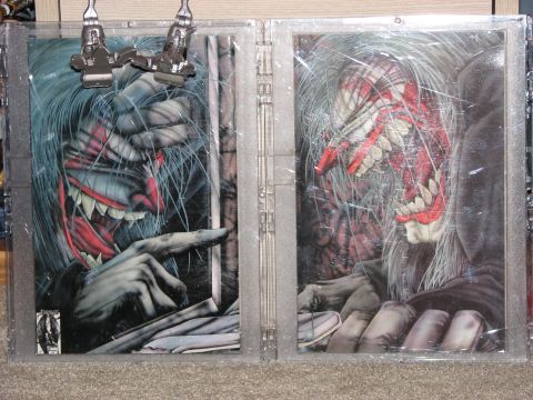 1991 Ford Bronco - The image displays two framed pieces of artwork monstrous, sharp-toothed figures, possibly from a comic book or graphic novel.