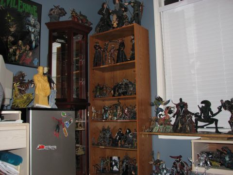 1991 Ford Bronco - A room filled with various action figures and collectibles displayed on shelves and a refrigerator.