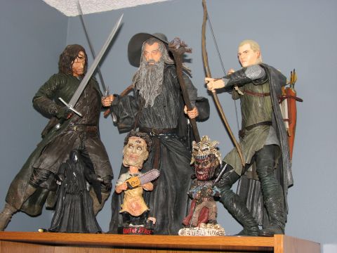 1991 Ford Bronco - A collection of action figures characters from Lord of the Rings and Texas Chainsaw Massacre displayed on a shelf.