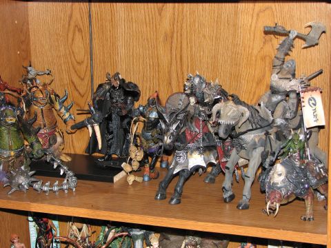 1991 Ford Bronco - A collection of fantasy action figures, including several on horseback, are displayed on a wooden shelf.