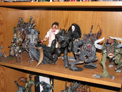 1991 Ford Bronco - A shelf displays a variety of detailed action figures, including characters from the Spawn comic series.