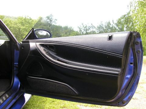 1994 Ford Probe - Interior view of a car door, showing the black door panel and speaker.