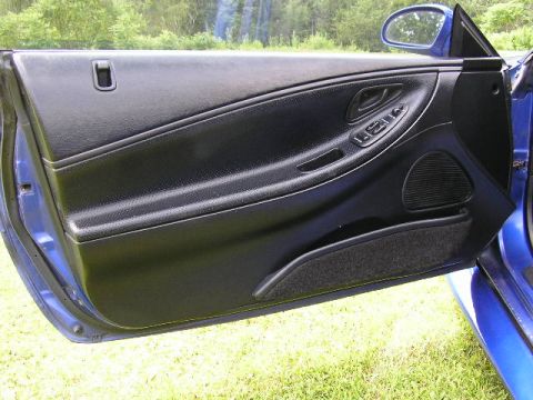 1994 Ford Probe - The interior door panel of a blue car is shown, black trim and controls for the windows.