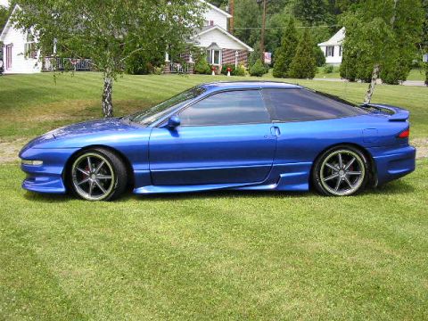 1994 Ford Probe - Side view of a blue 1994 Ford Probe GT with aftermarket wheels.