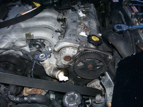 1994 Ford Probe - Close-up view of engine components, focusing on the timing belt and associated parts.