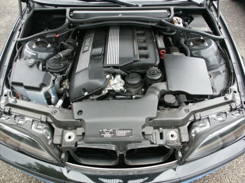 2001 Mercury Grand Marquis - The engine compartment of a BMW is shown, with the engine cover and various components clearly visible.