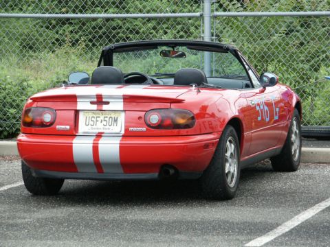 2001 Mercury Grand Marquis - Rear view of a red convertible sports car with racing numbers and silver stripes.