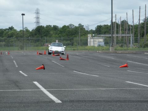 2001 Mercury Grand Marquis - A white coupe navigates a course marked by orange cones in an open lot.