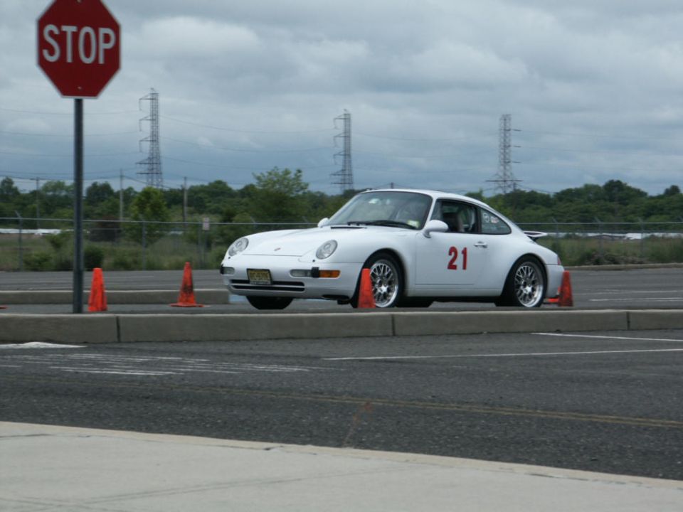 White Porsche 911 with number 21 on door, 3/4 front view