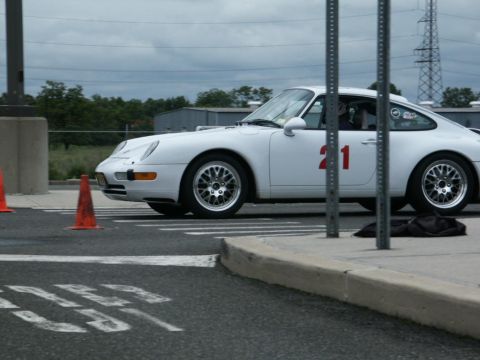 2001 Mercury Grand Marquis - White Porsche 911 with racing number 21 on its side, parked on a track with cones.