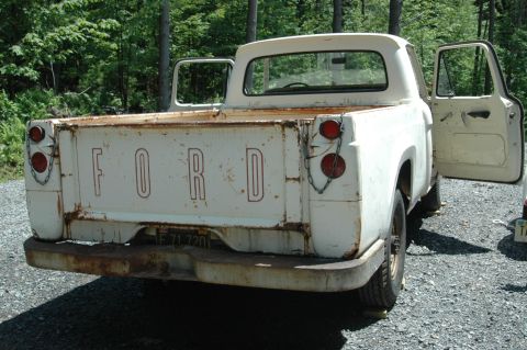 1963 Ford F-250 - This 1963 Ford F-250 pickup truck, seen from the rear with its doors ajar, appears to be a donor vehicle.