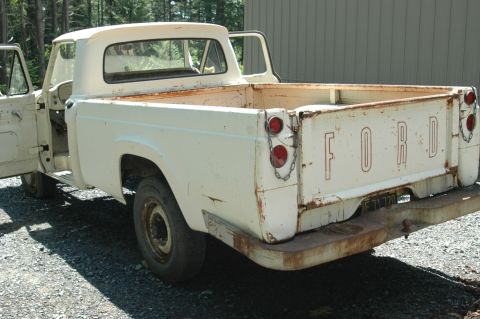 1963 Ford F-250 - This old Ford pickup truck shows significant rust and wear, with its tailgate down.