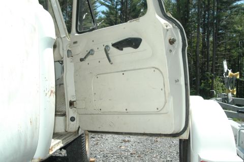 1963 Ford F-250 - Interior view of an old truck's driver side door, revealing its basic panel and hardware.