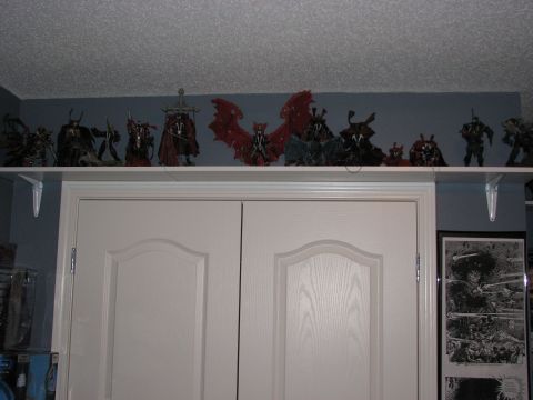 1991 Ford Bronco - A collection of Spawn action figures are displayed on a shelf above a set of closet doors.