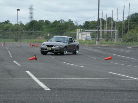 2001 Mercury Grand Marquis - Gray coupe on a track with cones. The vehicle appears to be a 2001 Ford Mustang.
