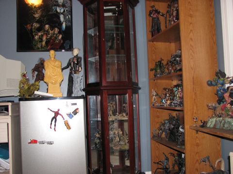 1991 Ford Bronco - A room filled with various action figures, statues, and collectibles displayed on shelves and a refrigerator.