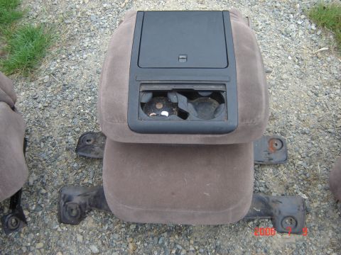 1993 Ford Bronco - This is a brown center jump seat with a black console and cup holders, likely from an older vehicle.