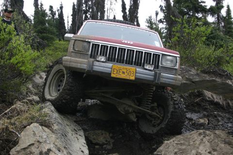 2003 Jeep TJ - Jeep Cherokee XJ navigating a challenging rocky off-road course in Alaska.