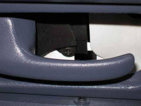 2001 Ford Crown Victoria - There is another screw behind the panel that surrounds the door handle .