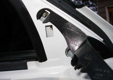 2001 Ford Crown Victoria - Pull back the trim to expose the three nuts that must be removed. The broken housing had 11mm nuts. You will need a deep socket extension.…
