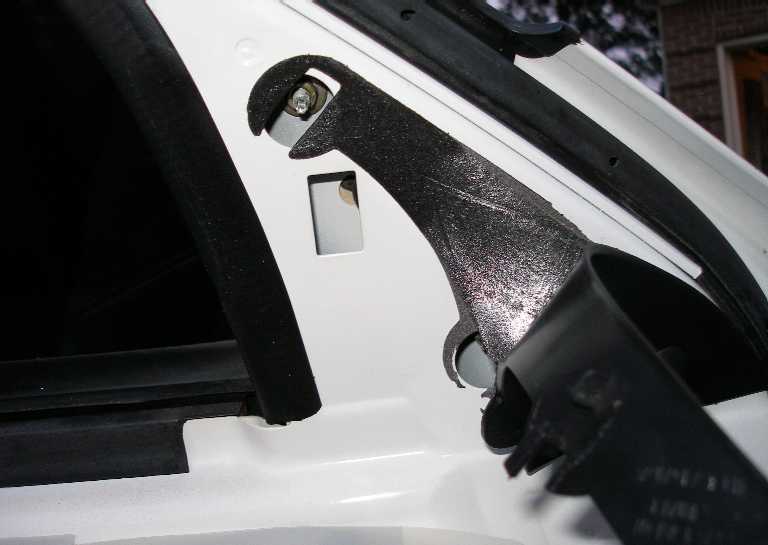 Pull back the trim to expose the three nuts that must be removed. The broken housing had 11mm nuts. You will need a deep socket extension. 

Unplug the mirror housing's connector and pull the housing off the door.

Installation is the reverse.