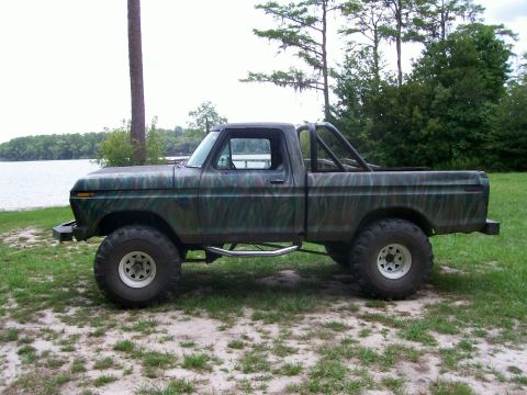 1990 Ford Bronco - This lifted 1979 Ford pickup truck has a custom camouflage paint job and a roll bar.