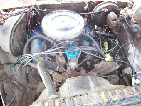 1990 Ford Bronco - Close-up view of a V8 engine bay, showing various components and wiring.