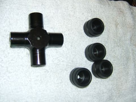 1993 Ford Bronco - A black universal joint and four black seals are laid out on a white towel.
