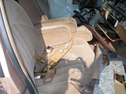 1998 Ford Crown Victoria - The interior of a vehicle is in disarray, with various components disassembled and lying around.