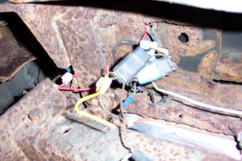 1978 Ford Bronco - Rusted vehicle frame section with visible wiring harness and connectors.