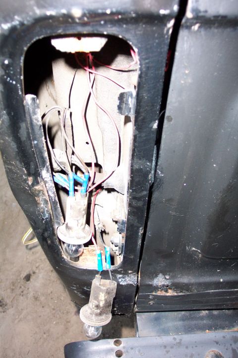 1978 Ford Bronco - Exposed wiring and bulb sockets within the tail light housing of a vehicle.