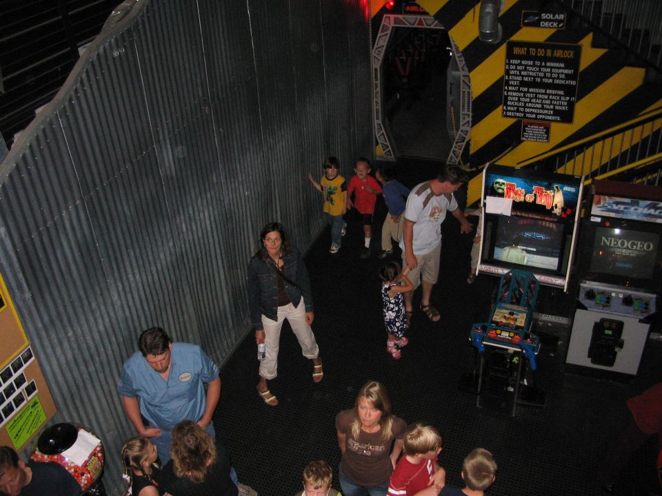 Arcade with people playing games, including Neo Geo and other cabinets