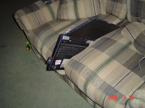 2005 Dodge 1500 - Laptop on couch with a toy car on the floor.