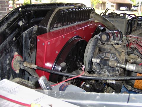 1978 Ford Bronco - Close-up view of dual electric fans installed on a radiator, a red shroud and various engine components.