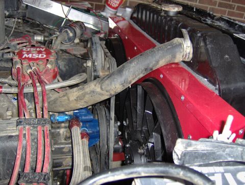 1978 Ford Bronco - Close-up of an engine bay MSD ignition parts and an aftermarket electric cooling fan.