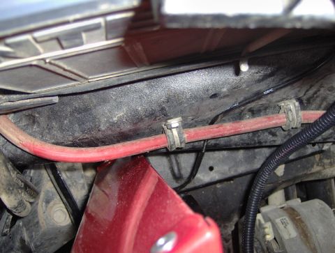 1978 Ford Bronco - Close-up view of wiring and a red cable in a vehicle's engine bay.