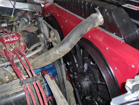 1978 Ford Bronco - Close-up of an engine bay showing aftermarket electric fans and ignition system parts.
