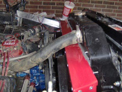 1978 Ford Bronco - Close-up view of an engine bay a red radiator shroud and MSD ignition components.